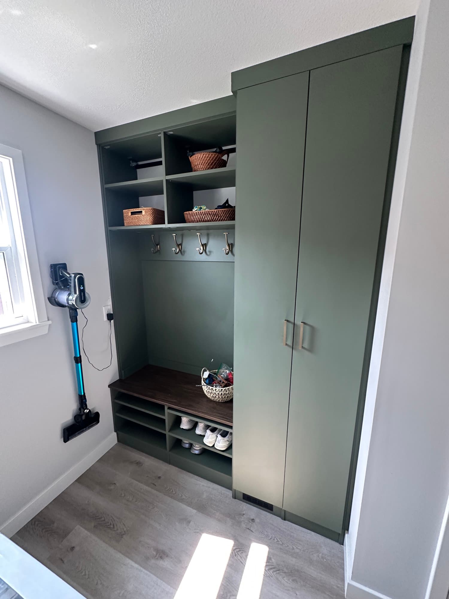 Small entryway drop zone with bench and hooks in Mid-Missouri