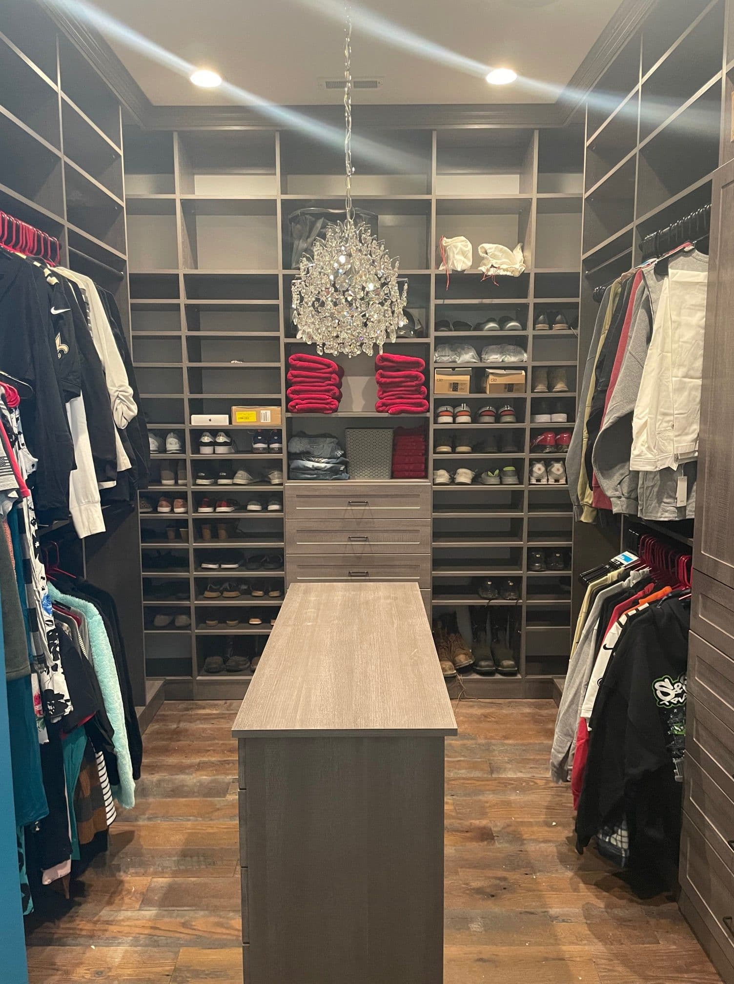 Luxury walk-in closet with chandelier and island at Lake of the Ozarks