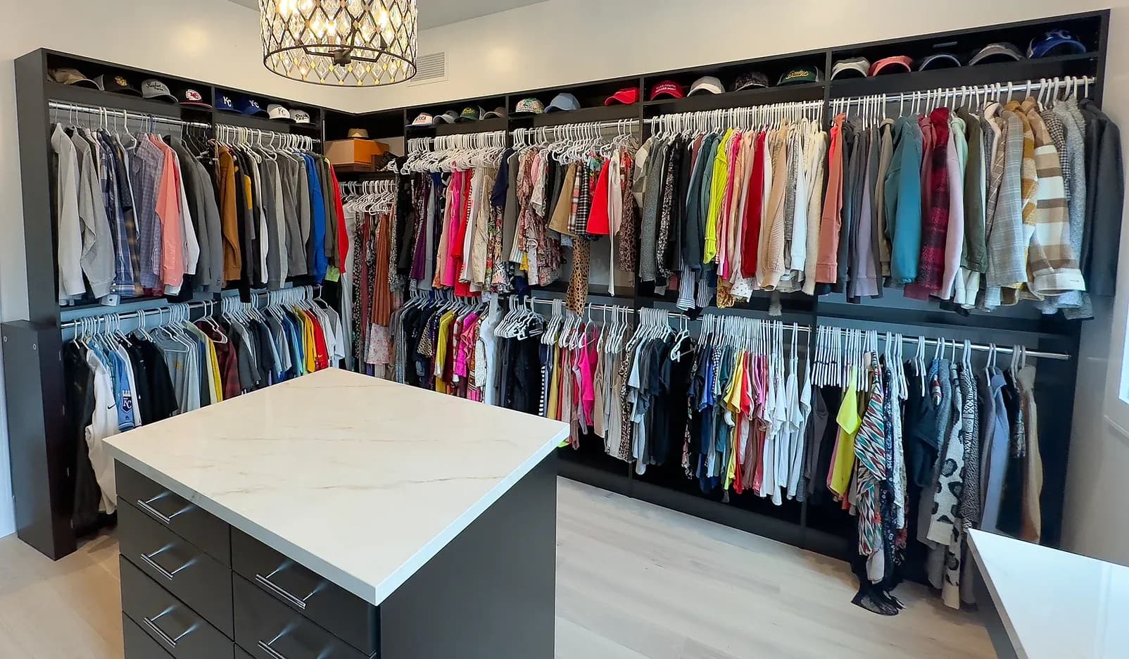 Master closet with dark island and double-hang