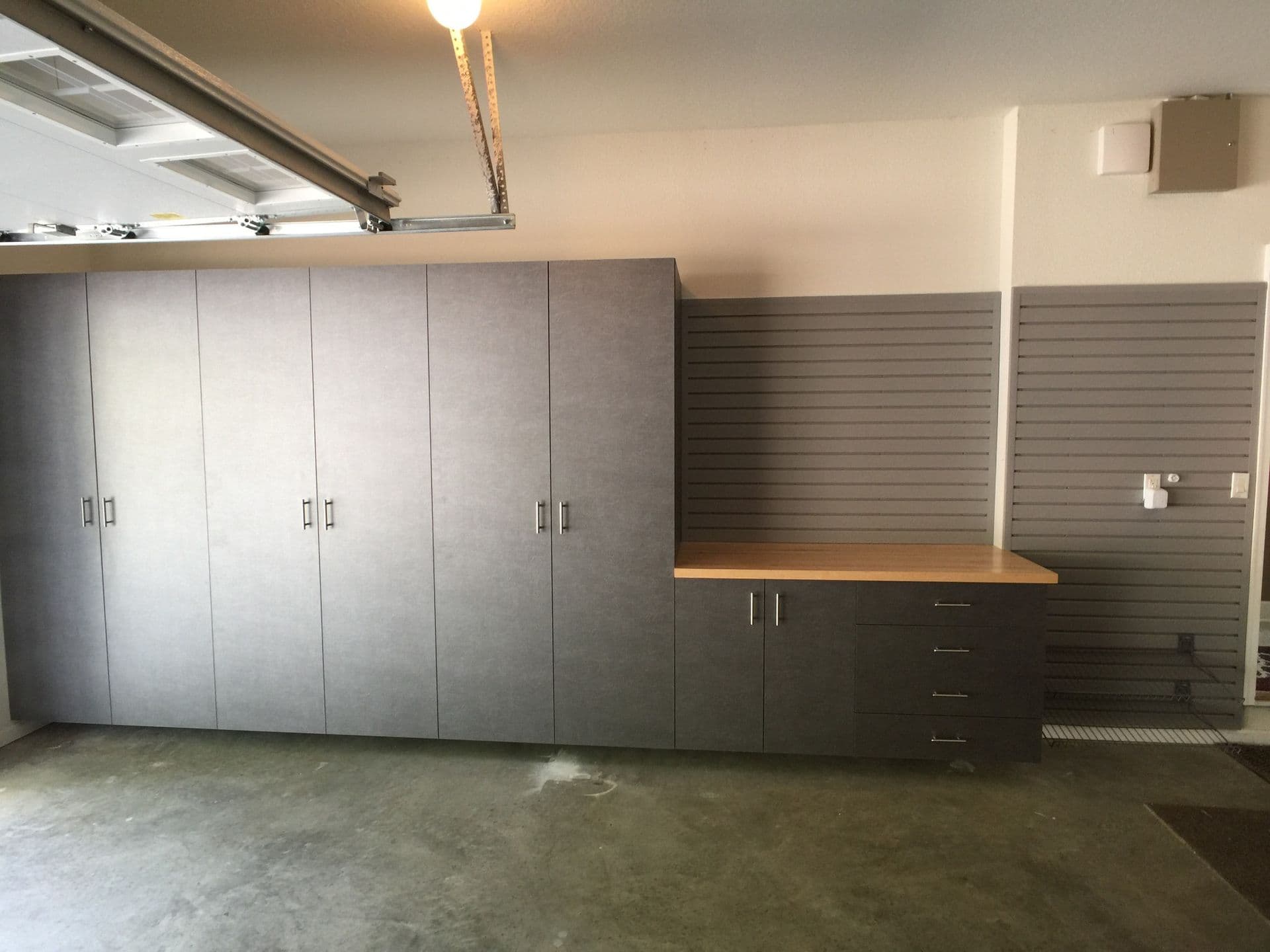 Garage workbench with gray cabinet storage in Columbia, MO