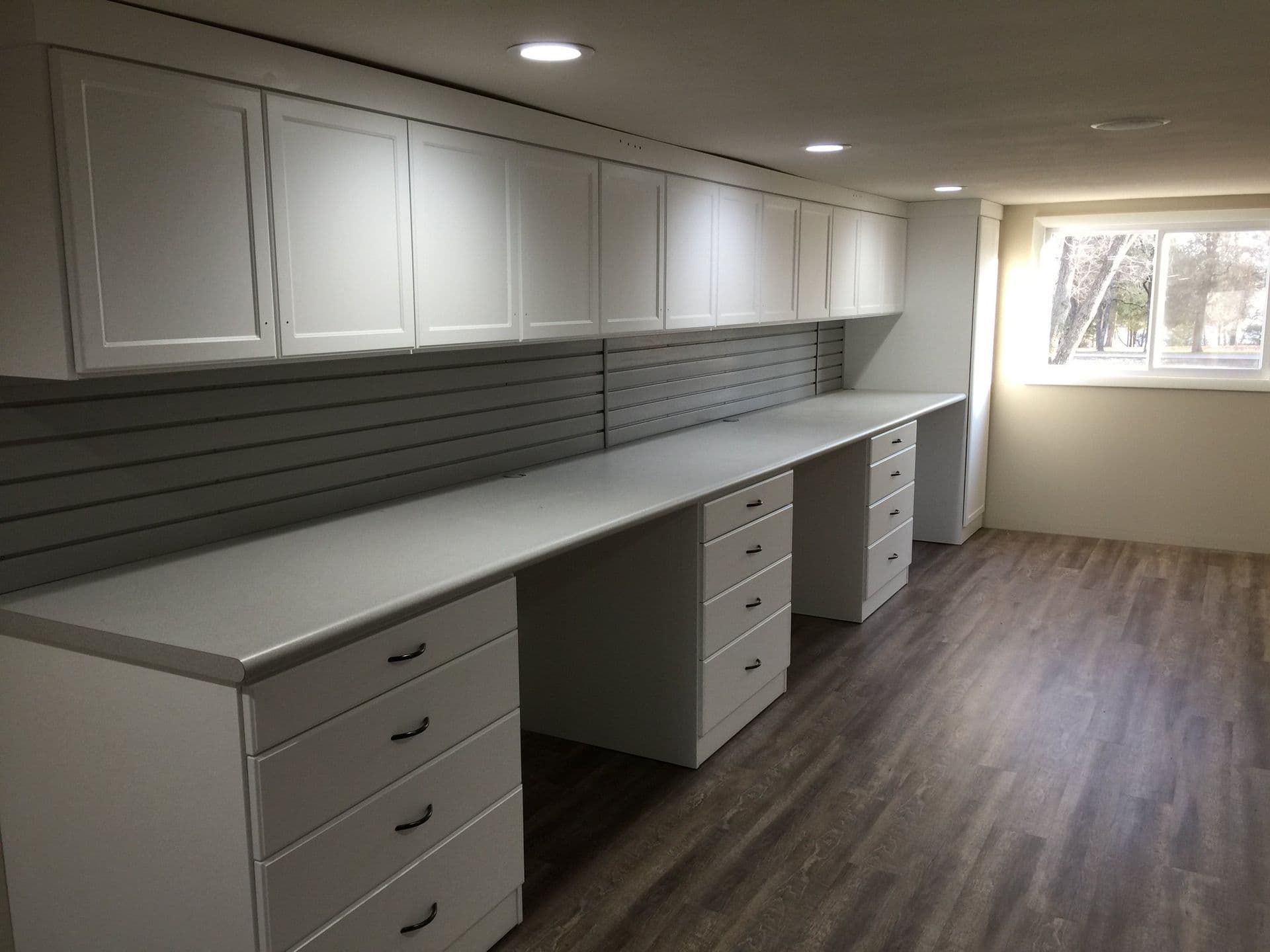Home office with long workstation and slatwall
