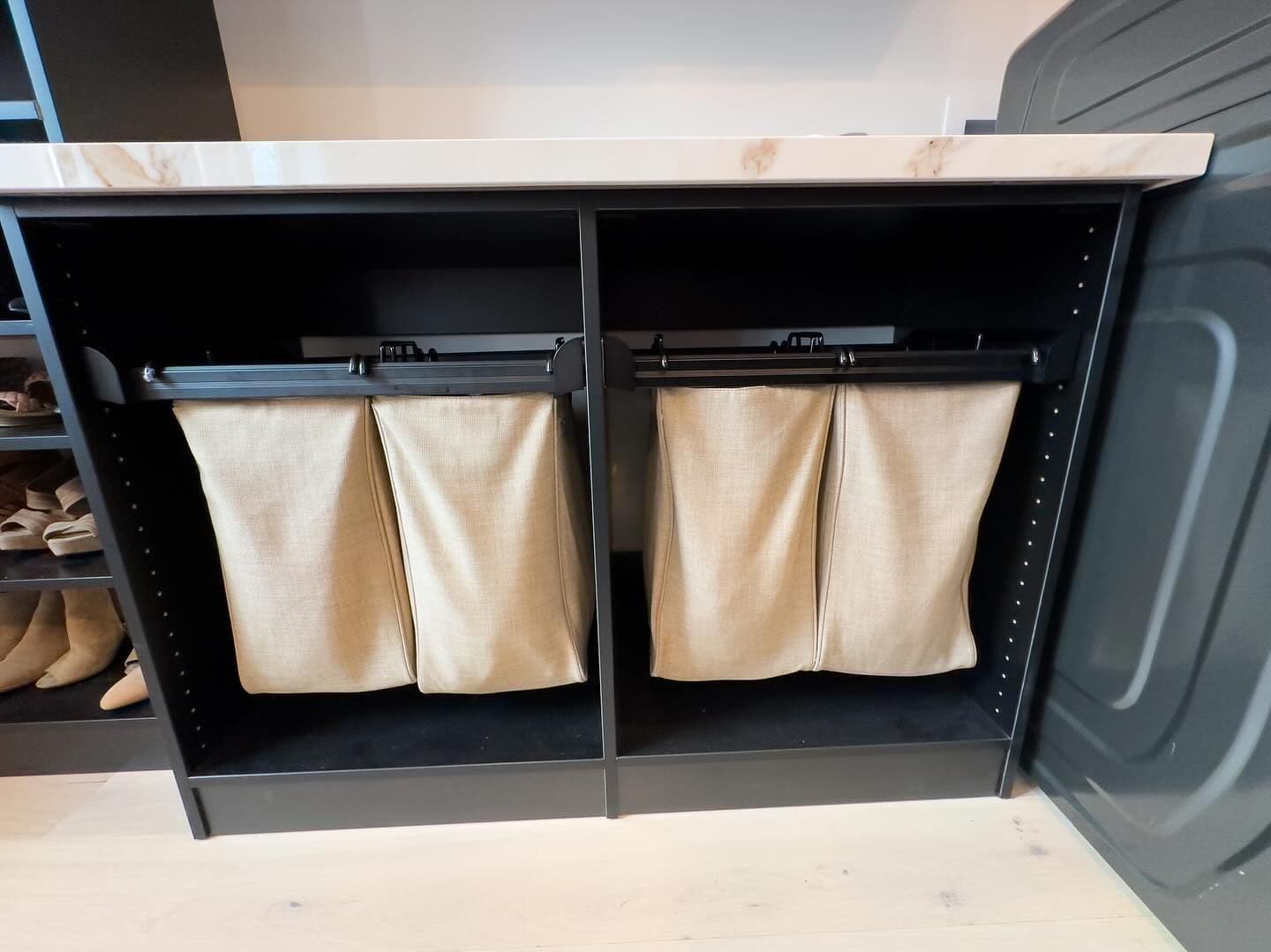 Custom laundry room with slide-out hamper storage in Columbia, MO