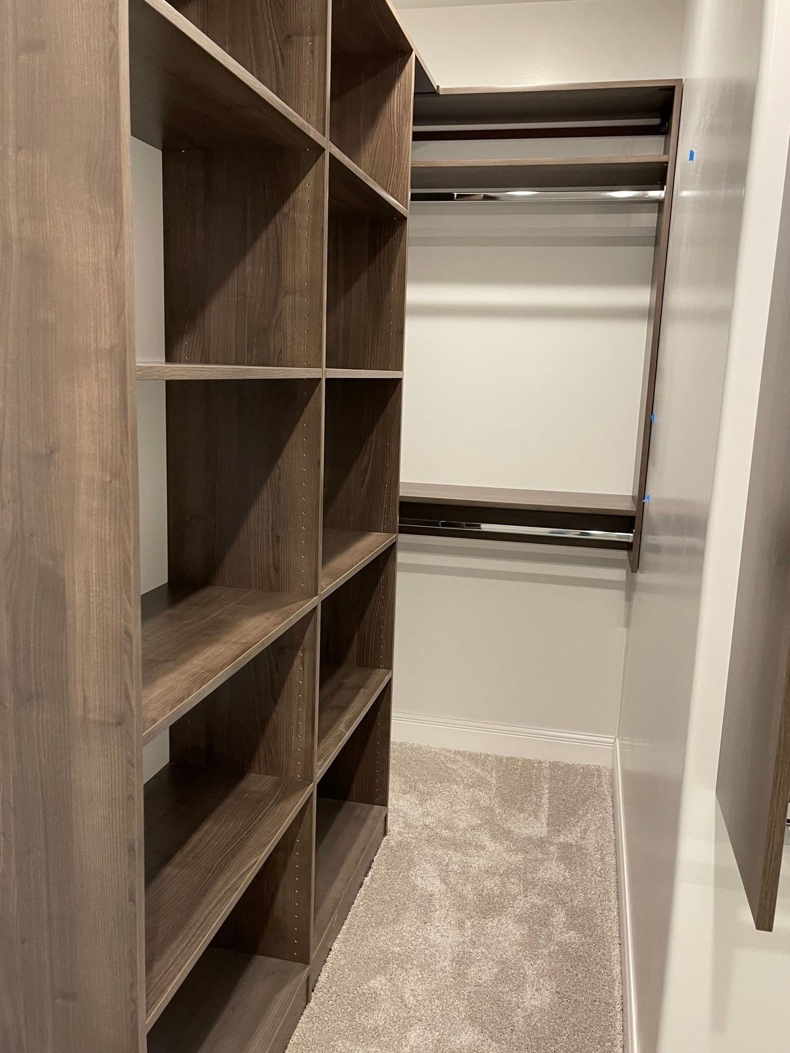 Dark wood reach-in closet with cubby storage in Columbia, MO